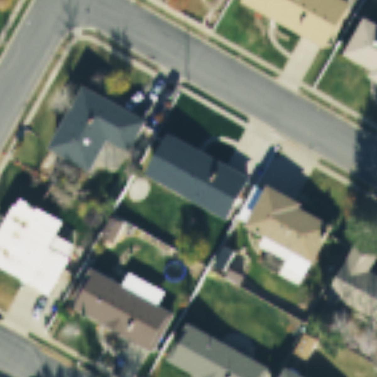 Original 2021 aerial photograph of the same property, before the AI pool concept